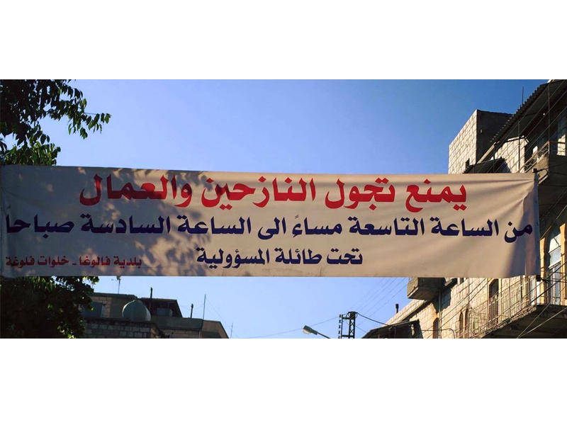 لافتة تدعو النازحين والعمال إلى عدم التجول ليلاً في بلدتي فالوغا وخلوات فالوغا في قضاء بعبدا