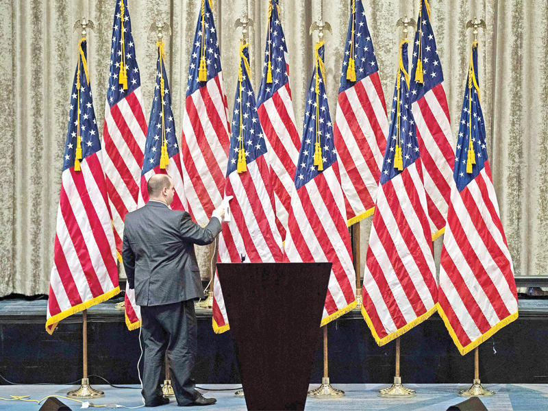 متطوع جمهوري قبل ظهور ترامب وبينس بفندق ميد تاون في نيويورك أمس (أ ف ب)