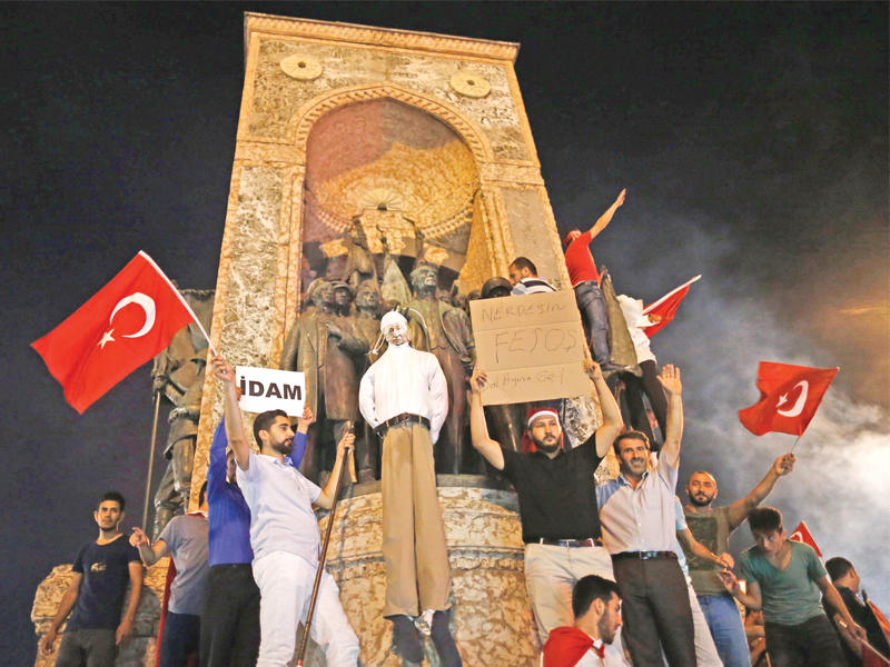 أنصار إردوغان يشنقون دمية تمثل غولن مطالبين باعادة عقوبة الإعدام وذلك خلال تجمع في ميدان تقسيم بإسطنبول أمس الأول   (إي بي أيه)