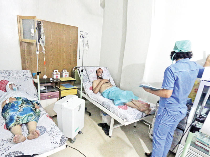 سوريان أصيبا في قصف الغاز على حي الزبدية يتلقيان العلاج في مستشفى القدس أمس  (رويترز)