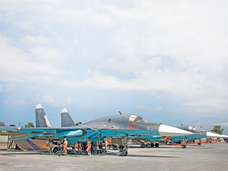 روس يجهزون قاذفة سوخوي بالصواريخ في قاعدة حميميم مطلع مايو 2016  (إي بي إيه)