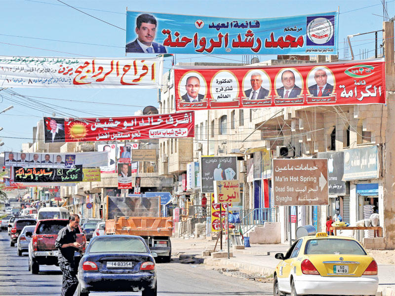 الإعلانات الانتخابية تملأ شوارع مدينة مادبا قرب عمان أمس (رويترز)