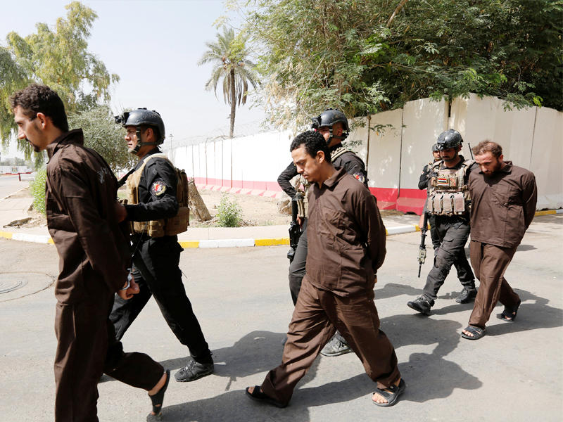 جنود عراقيون يقتادون عناصر من «داعش» اعتقلوا في بغداد أمس    (رويترز)