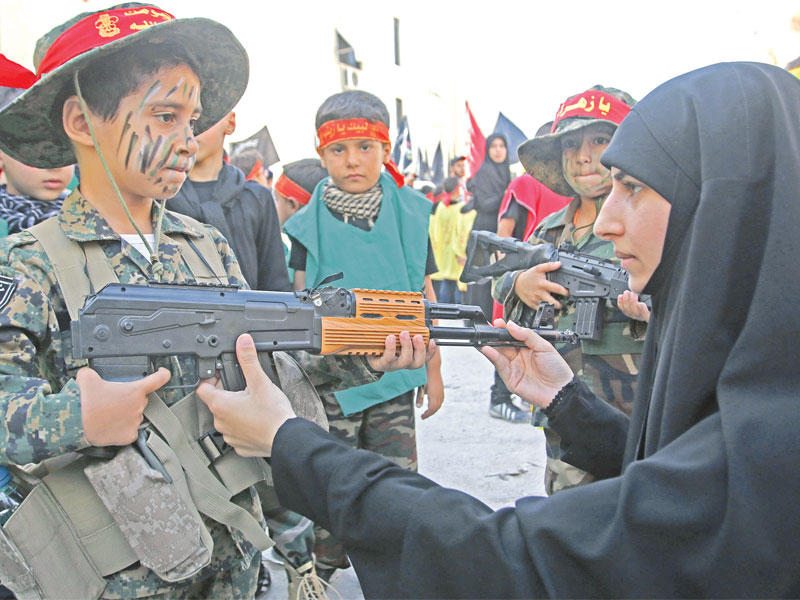 طفل مشارك بمسيرة نظمها حزب الله بمناسبة السابع من المحرم في بلدة السكسكية أمس الأول  ( أ ف ب)