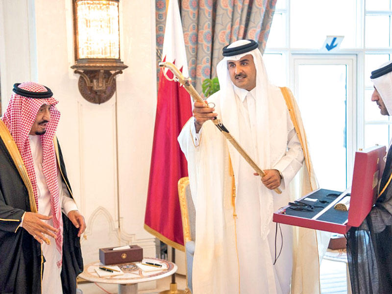 أمير قطر الشيخ تميم يهدي للعاهل السعودي «سيف المؤسس» وهو أرفع وأعلى الأوسمة القطرية في الدوحة أمس (واس)   