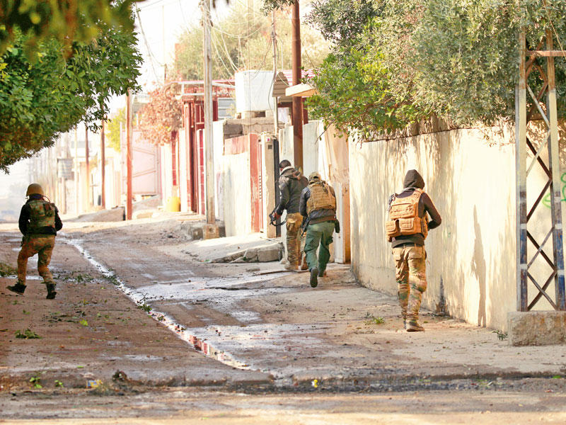 جنود عراقيون يخوضون حرب شوراع في حي الميثاق شرق الموصل أمس الأول (رويترز)