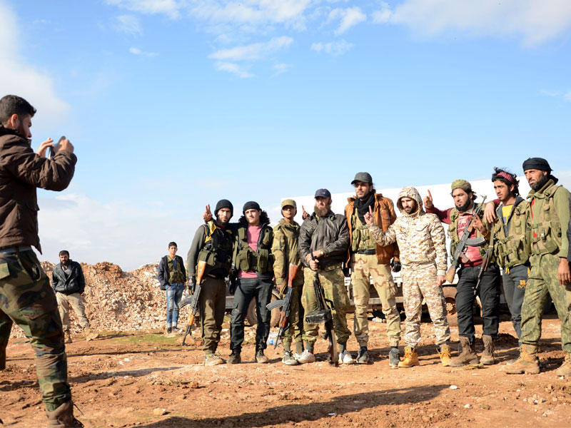 مقاتلون من الجيش الحر يلتقطون الصور قرب بلدة قباسين شمال شرقي مدينة الباب أمس الأول (أ ف ب)