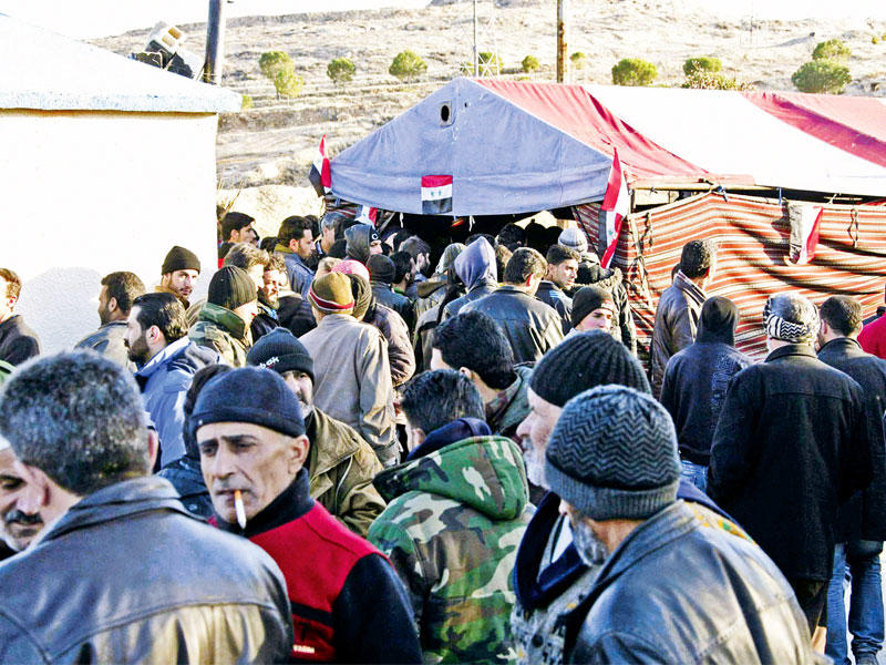 صورة نشرتها وكالة الأنباء السورية الرسمية «سانا» لمجموعة من مدنيي وادي بردى تنتظر تعديل وضعها لمنحها ممراً آمناً للخروج من المنطقة أمس الأول