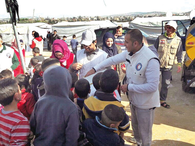 جانب من عملية توزيع المساعدات على الأسر السورية النازحة