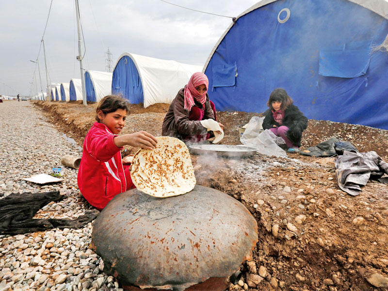 عراقيات في مخيم للاجئين من الموصل في الخازر أمس (رويترز)