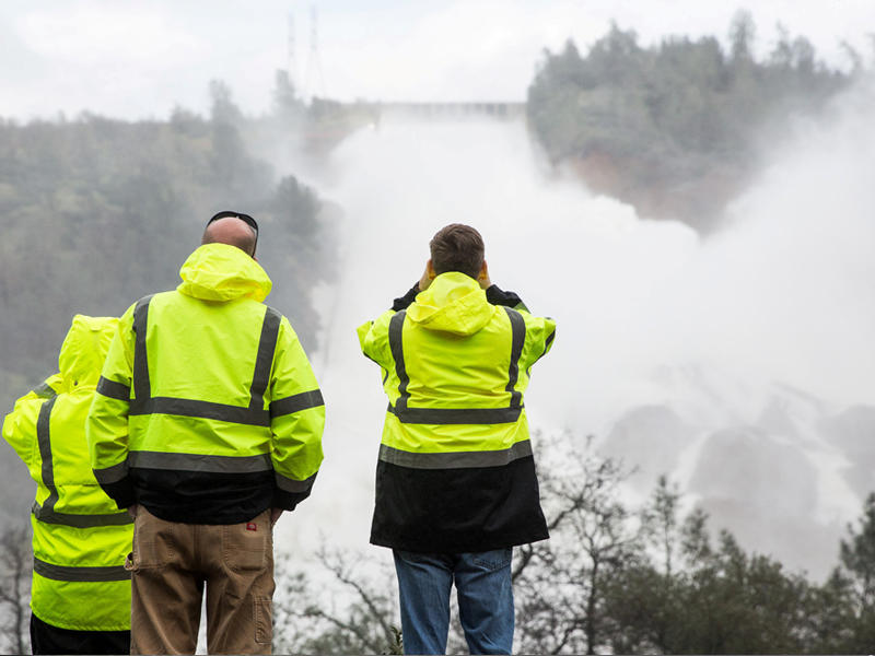 رجال الطوارئ يراقبون منسوب المياه خلف السد - رويترز
