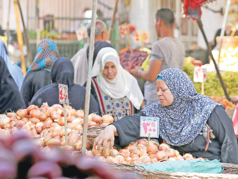 سيدات مصريات يتبضعن من سوق خضراوات وسط القاهرة أمس الأول (رويترز)