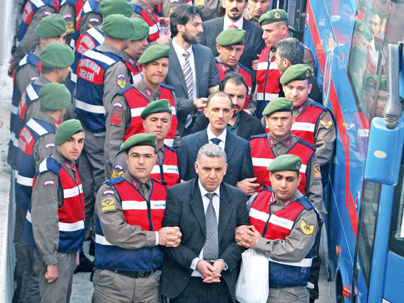 جنود أتراك يتوجهون إلى قاعة المحكمة يرافقون متهمين بمحاولة اغتيال الرئيس إردوغان خلال محاولة الانقلاب في يوليو الماضي (رويترز)