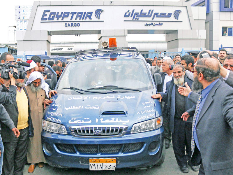 قادة بـ«الجماعة الإسلامية» وأقارب يلتفون حول سيارة تحمل جثمان المرشد الروحي للجماعة عمر عبدالرحمن الذي توفي بمحبسه في الولايات المتحدة عقب وصوله إلى القاهرة أمس (أ ف ب)