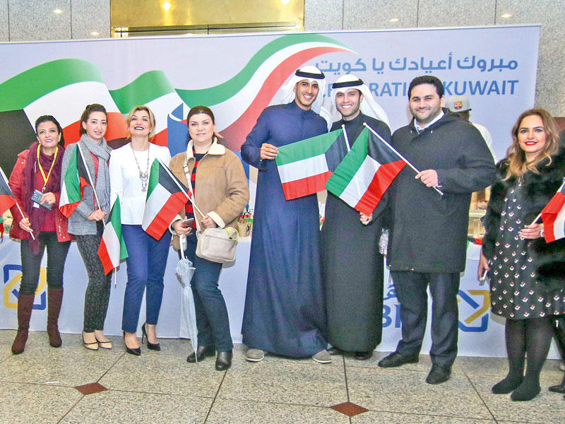 موظفو «الأهلي» خلال الاحتفال بالأعياد الوطنية