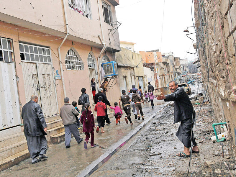 نازحون يفرون من المعارك في الموصل وسط سوء الأحوال الجوية أمس (رويترز) 
