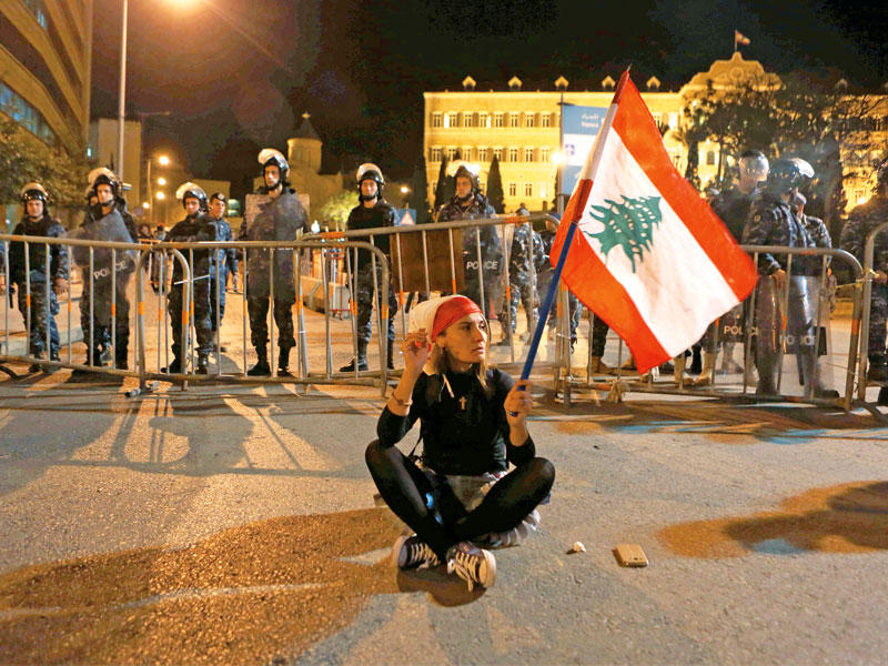 لبنانية تعترض على الضرائب أمام السراي الحكومي ببيروت أمس الأول (أ ف ب)