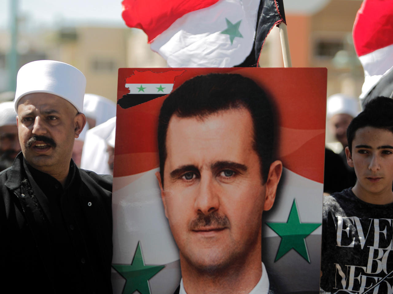 دروز في قرية مسعدة التي تحتلها إسرائيل يحملون صورة للرئيس السوري بشار الأسد خلال تجمع بمناسبة عيد الاستقلال