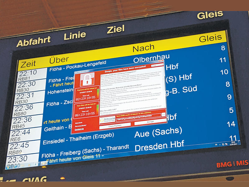 نافذة ظهرت على شاشة الجدول الزمني للرحلات تعلن عن تشفير البيانات بما في ذلك طلب دفع في محطة كيمنتس شرق ألمانيا أمس الأول ( أ ف ب)