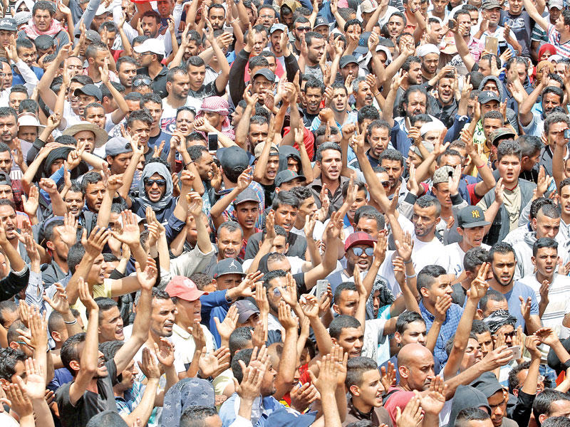 تونسيون يشاركون أمس الأول في جنازة شاب قتل دهساً بالخطأ خلال احتجاجات تطاوينt (رويترز)