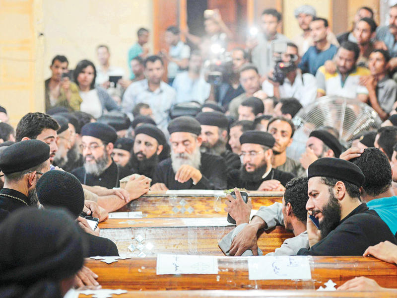 جانب من تأبين بعض ضحايا اعتداء «داعش» داخل كنيسة في المنيا  أمس  (أ ف ب)