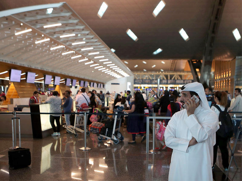 مسافرون يستعدون للمغادرة بمطار حمد الدولي في الدوحة أمس الأول (أ ف ب)