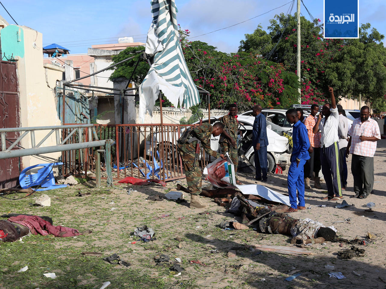 عناصر الأمن يفحصون الجثث في موقع الهجوم في مقديشو