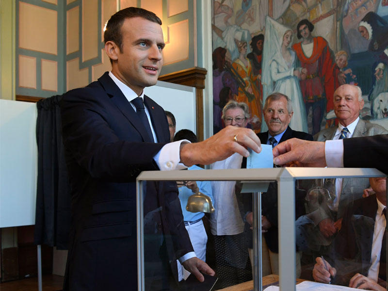 الرئيس الفرنسي إيمانويل ماكرون  يلقي اقتراعه في تصويته في الجولة الثانية من الانتخابات التشريعية الفرنسية 
