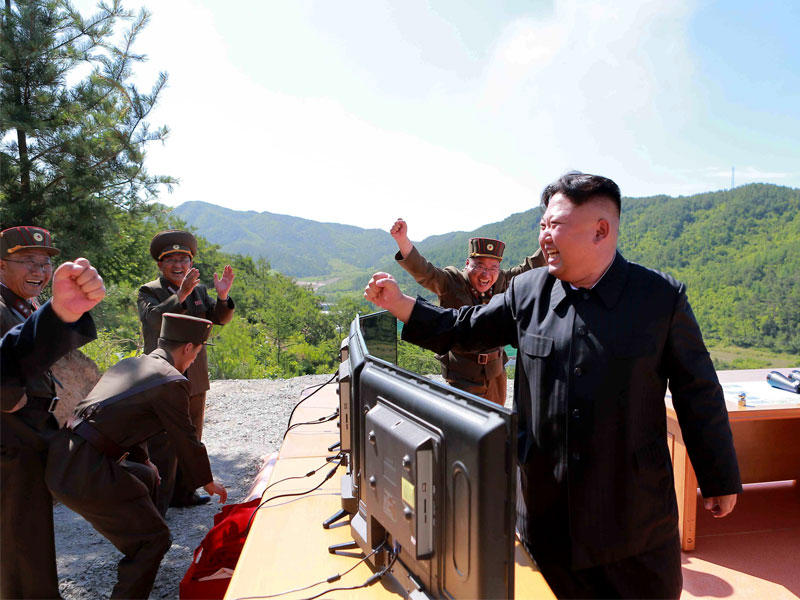 زعيم كوريا الشمالية محتفلاً مع جنرالاته بتجربة الصاروخ في صورة وزعتها وكالة الانباء الكورية اليوم 