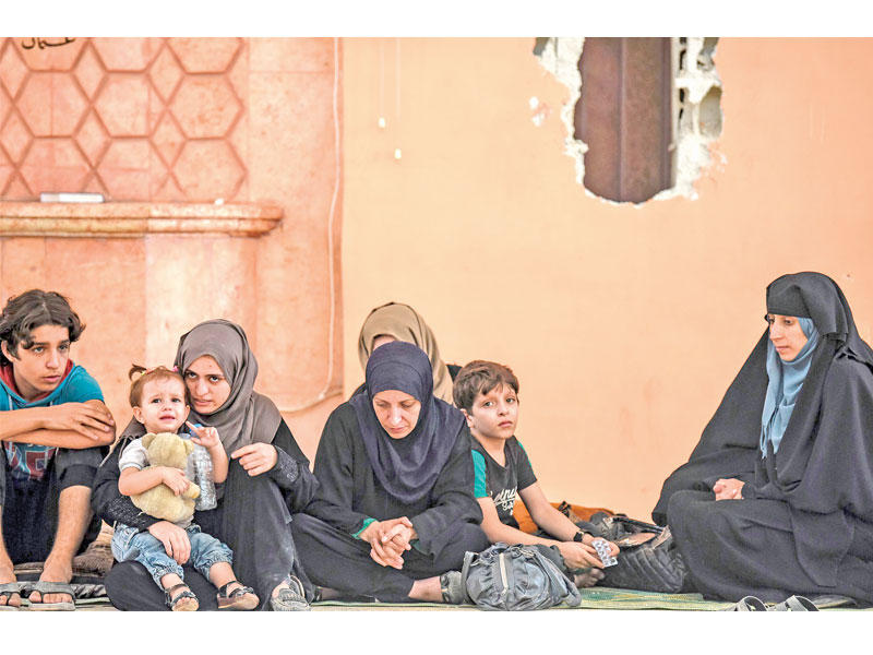 سوريون فارون من الرقة ( أ ف ب)