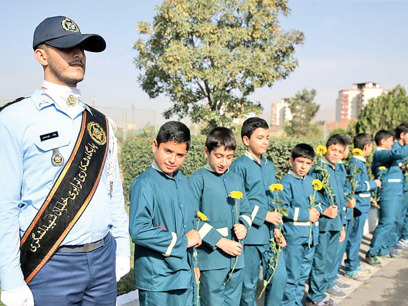 فتية إيرانيون خلال دفن بقايا جنود قتلوا في الحرب مع العراق (إرنا)