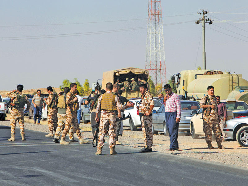 قوات البيشمركة على طريق ألتون كوبري بين كركوك وأربيل أمس (رويترز)