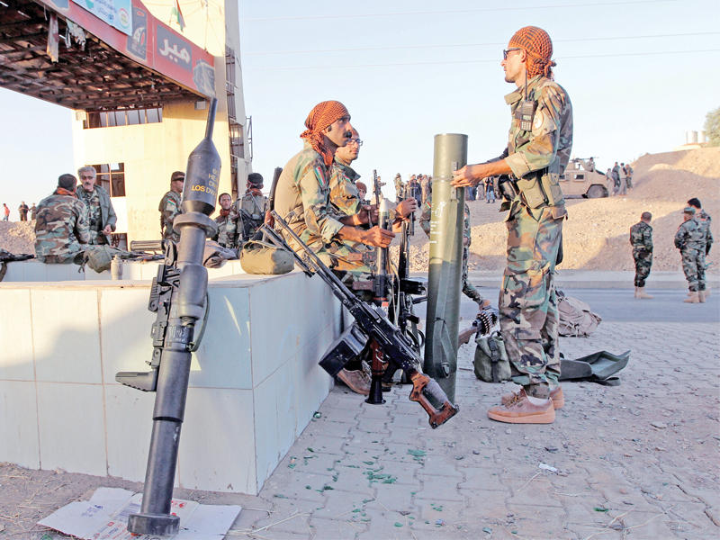 مقاتلون أكراد في التون كوبري أمس الأول (رويترز)