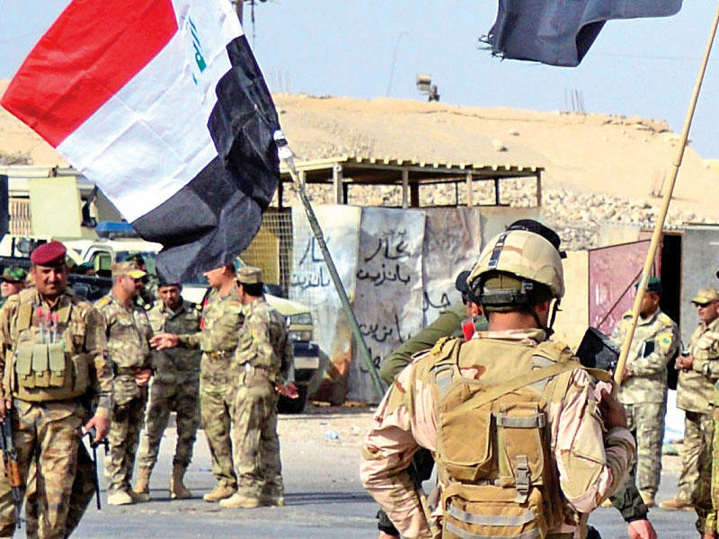 القوات العراقية بعد دخولها قضاء راوه أمس الأول (رويترز)
