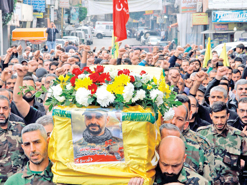 مناصرون لـ «حزب الله» يشيعون في الضاحية الجنوبية لبيروت أمس قتيلاً سقط في سورية   (أ ف ب)