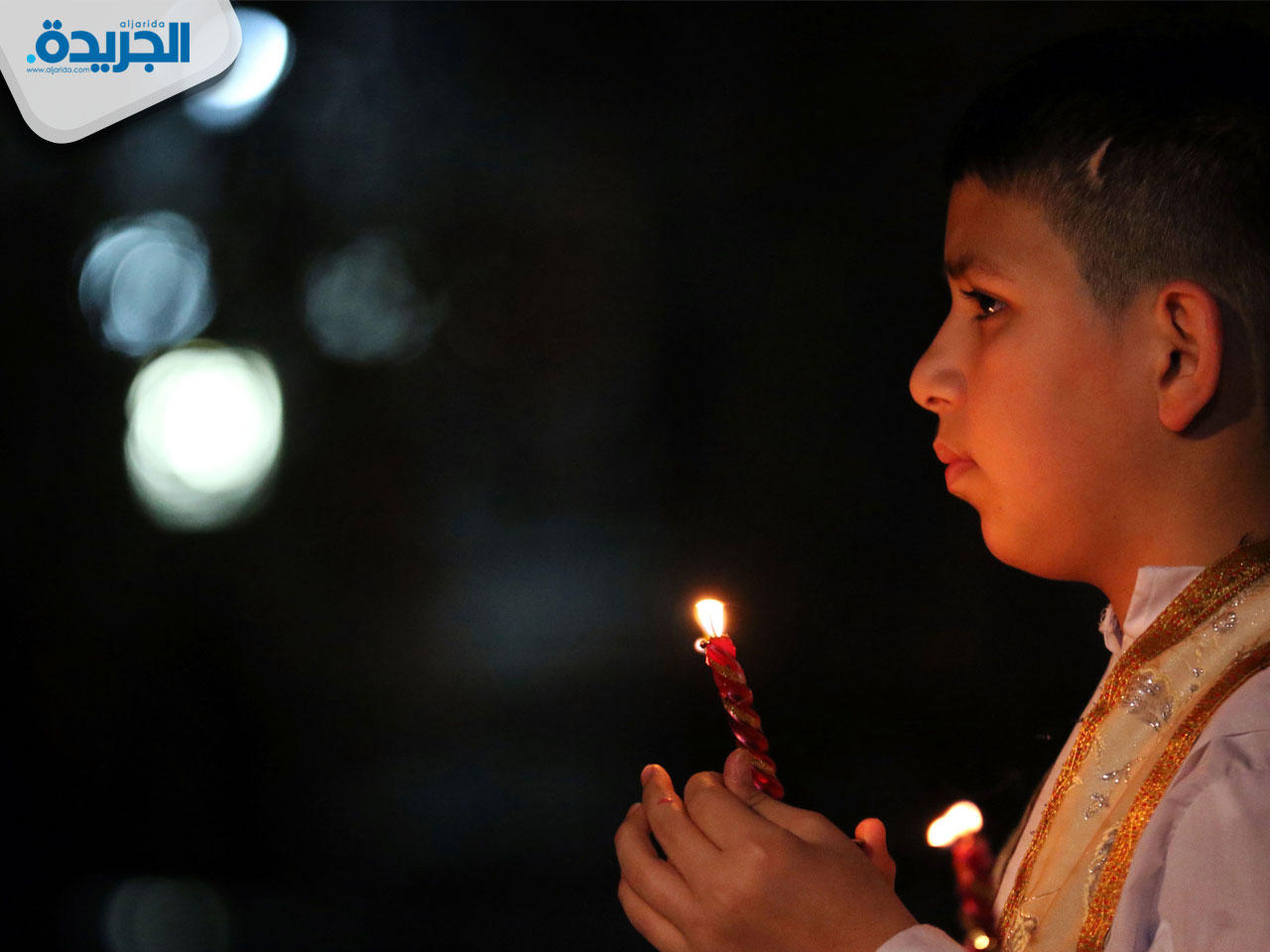 طفل عراقي أثناء قداس عيد الميلاد