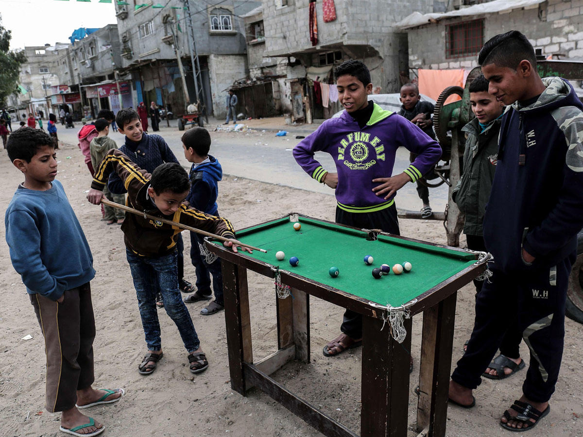 فتية فلسطينيون يلعبون البلياردو على طريقتهم في غزة أمس (أ ف ب) n