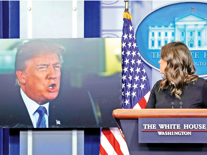 الناطقة باسم البيت الأبيض تستمع إلى كلمة مسجلة لترامب خلال مؤتمرها الصحافي اليومي أمس الأول t(رويترز)