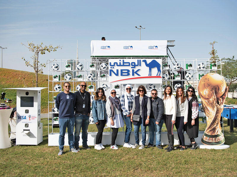 فريق العلاقات العامة في جناح «الوطني» بالمعرض