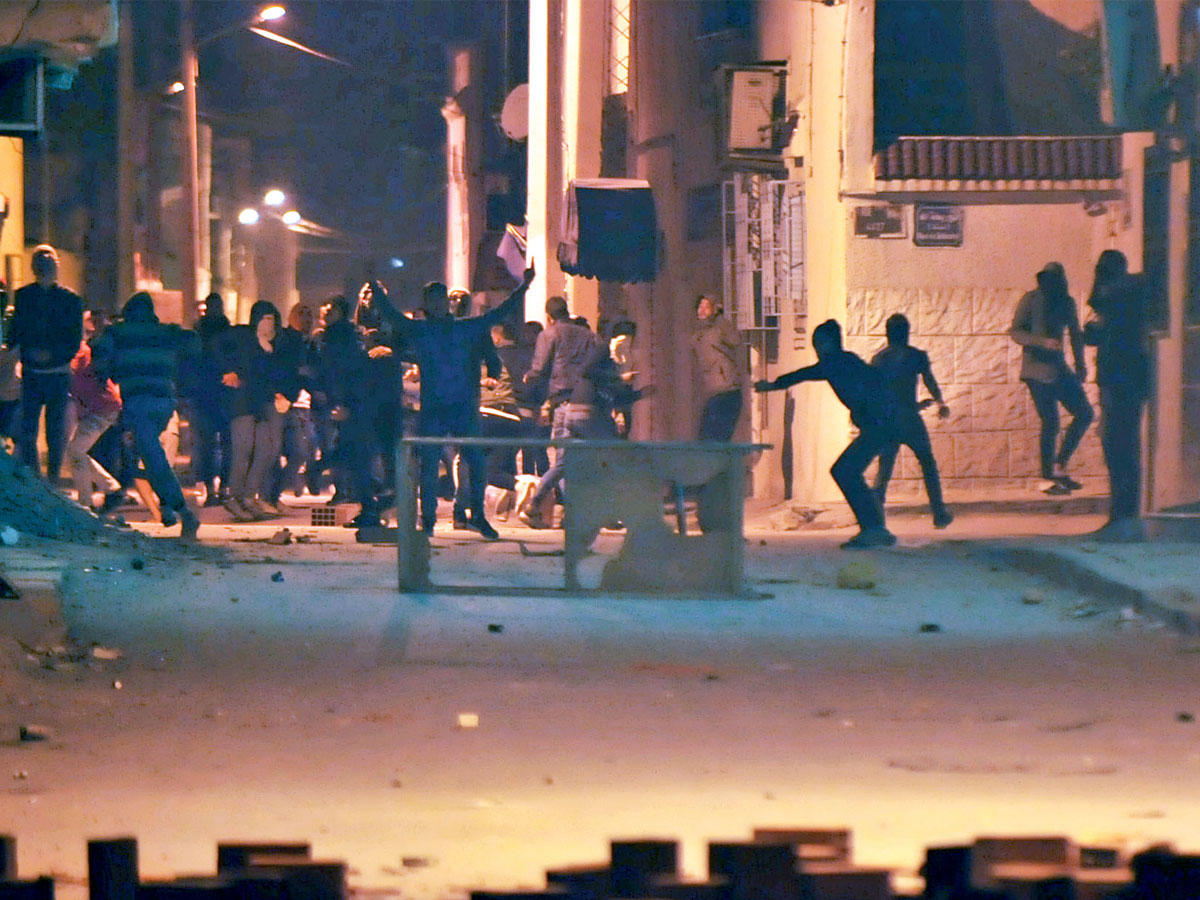 محتجون تونسيون يرشقون قوات الأمن بالحجارة  ليل الثلاثاء - الأربعاء في الجبل الأحمر (أ ف ب)