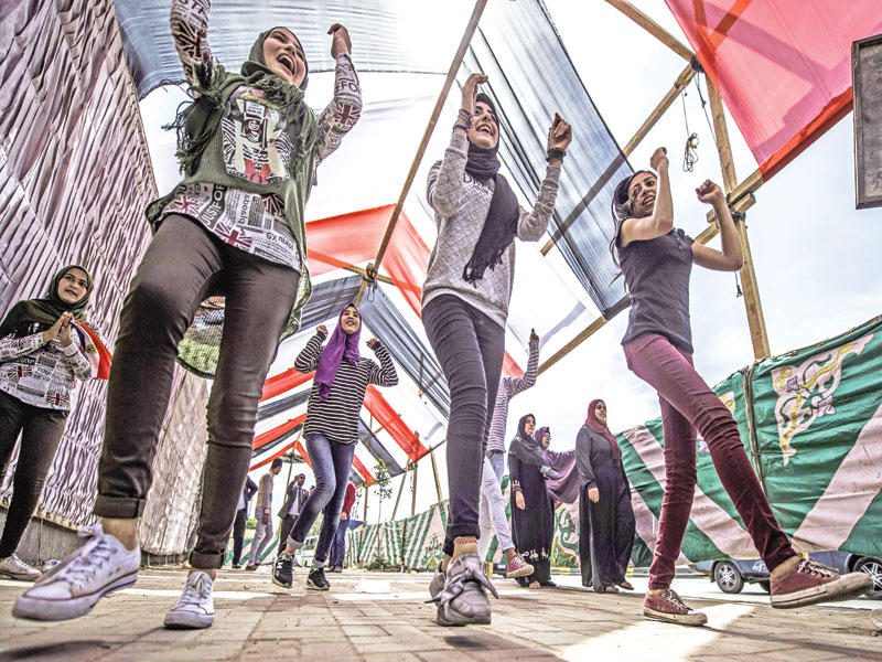 شابات مصريات في رقصة أمام مركز انتخابي في شبرا الخيمة أمس  (أ ف ب)