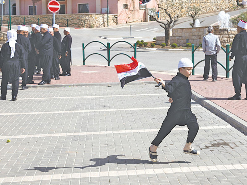 دروز في القسم الذي تحتله إسرائيل من الجولان يحتفلون بعيد الجلاء قبل أيام (رويترز)
