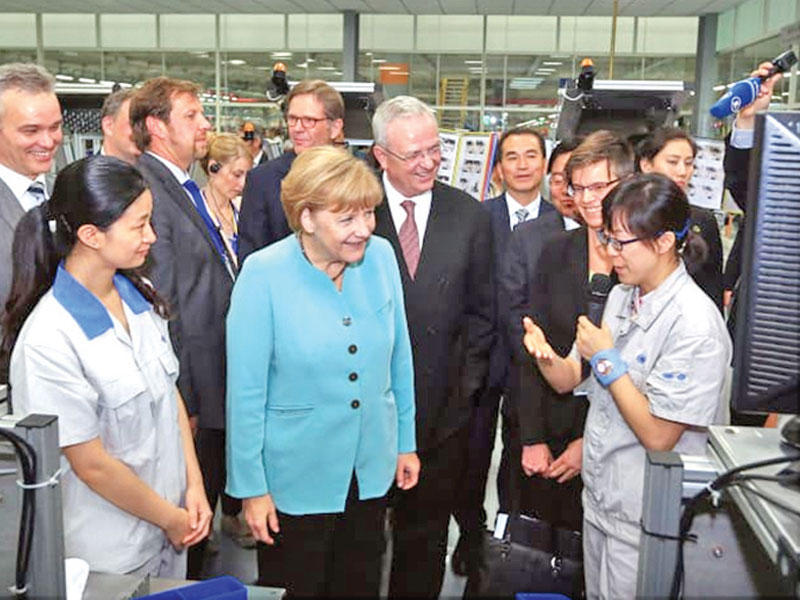 المستشارة الألمانية ميركل في زيارة سابقة لأحد مصانع فولكسفاغن في الصين