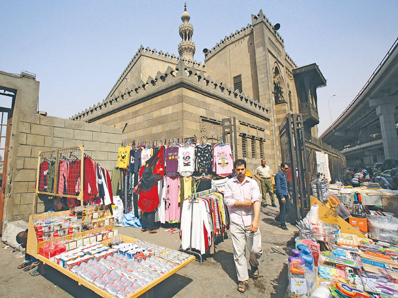 مصريون بسوق شعبي وسط القاهرة الأربعاء الماضي  (إي بي أيه)