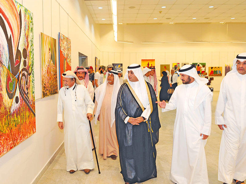 الدويش وعدد من الحضور خلال افتتاح المعرض