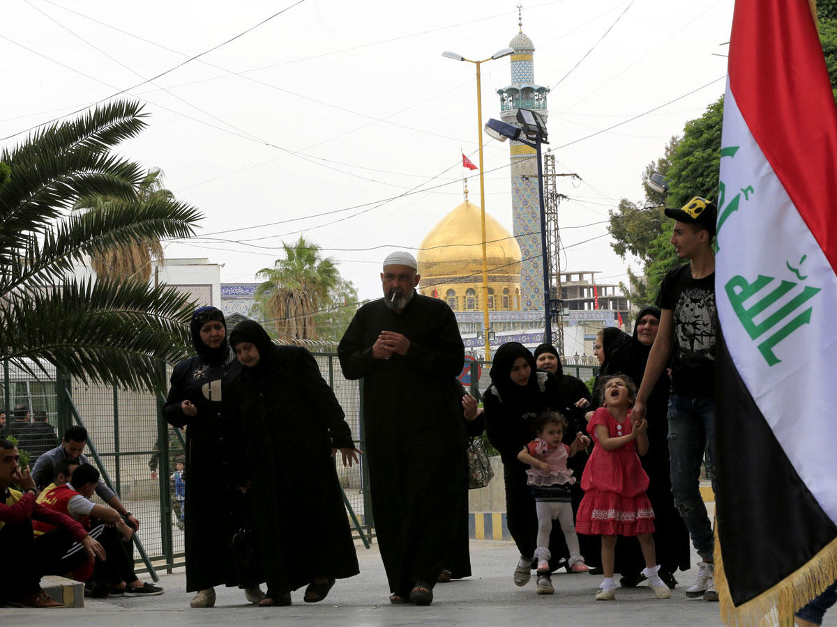 عراقيون في طريقهم للاقتراع في حي السيدة زينب بدمشق أمس الأول (أ ف ب)
