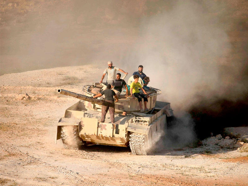 مقاتلو المعارضة على دبابة في درعا أمس الأول (أ ف ب)