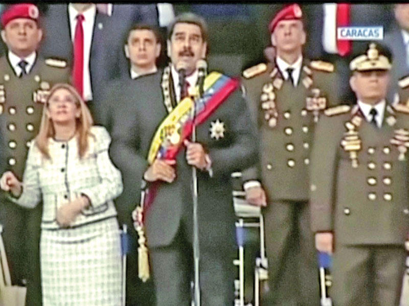 مادورو وزوجته في لقطة تلفزيونية لحظة وقوع الانفجارات خلال لحظات من العرض العسكري في كاراكاس أمس الأول (رويترز)