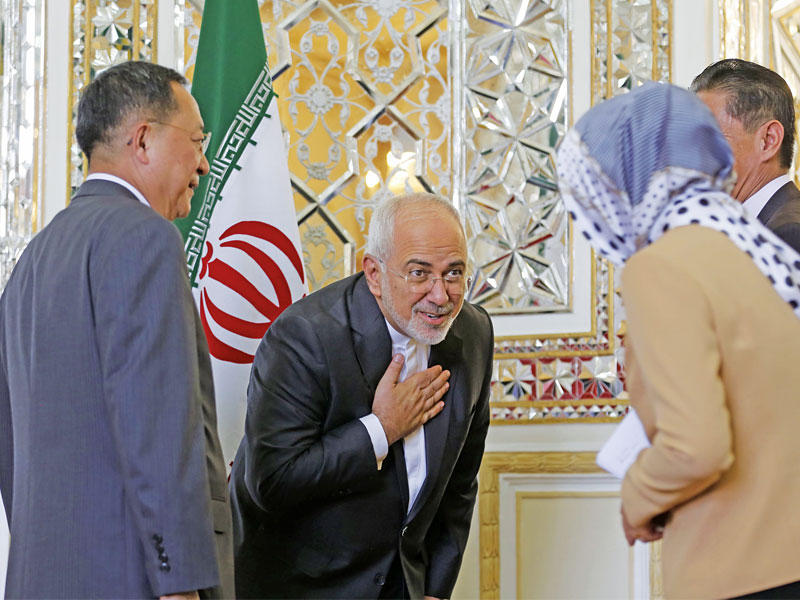 وزير الخارجية الإيراني محمد جواد ظريف ينحني لدبلوماسية كورية شمالية رافقت وزير خارجية بلادها ري يونغ هو إلى طهران أمس (أ ف ب)