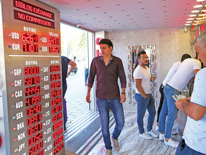 أتراك داخل صرافة في إسطنبول أمس (إي بي أيه)